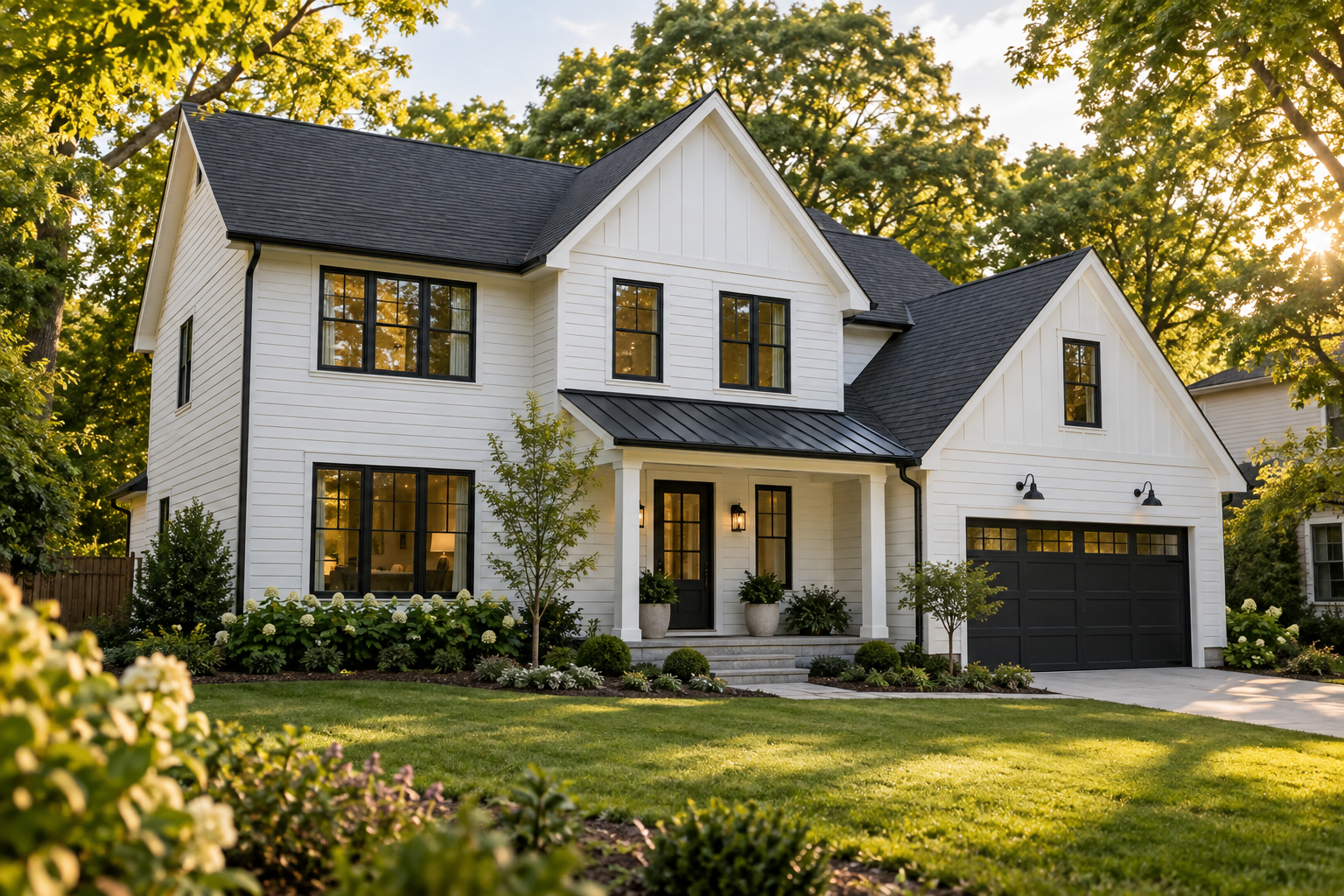 A sunlit white home surrounded by trees